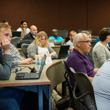 Students take notes in class for Business Analytics program