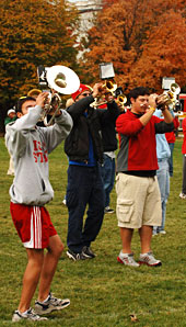 Marching band members rehearse on campus