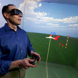 Eliot Winer operates the controls of Iowa State's C6 virtual reality room.