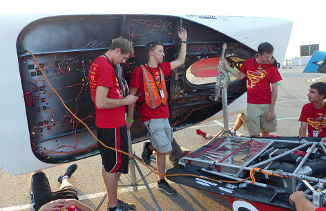 Students recharging the Team PrISUm solar racing car