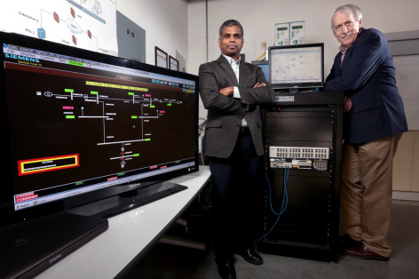 Manimaran Govindarasu and Doug Jacobson witih the "PowerCyber" grid security testbed.