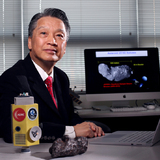 Bong Wie in his office with a model of his asteroid interceptor and a fragment from a meteorite.