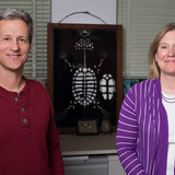 Fredric Janzen and Anne Bronikowski stand in front of a display of turtle bones.
