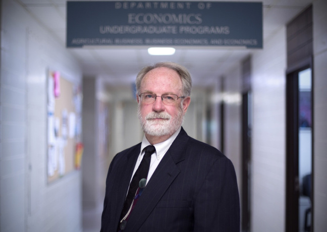 Mark Edelman stands in the ISU Department of Economics
