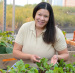 Angela Shaw tends plants in an ISU greenhouse