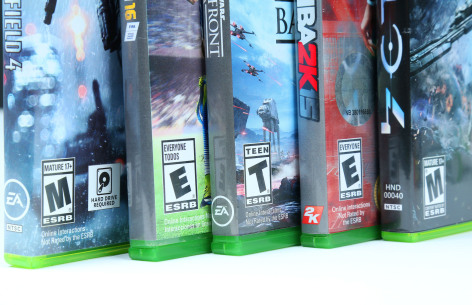 Side view of video game packages with ratings