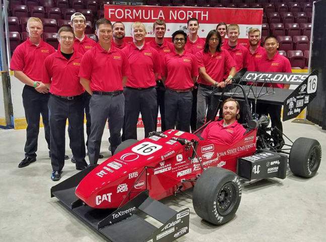 The Iowa State Formula SAE team members and their racing car at Formula North in Canada.
