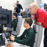 Retired astronaut Clayton Anderson works with a student during this year's Spaceflight Operations Workshop.