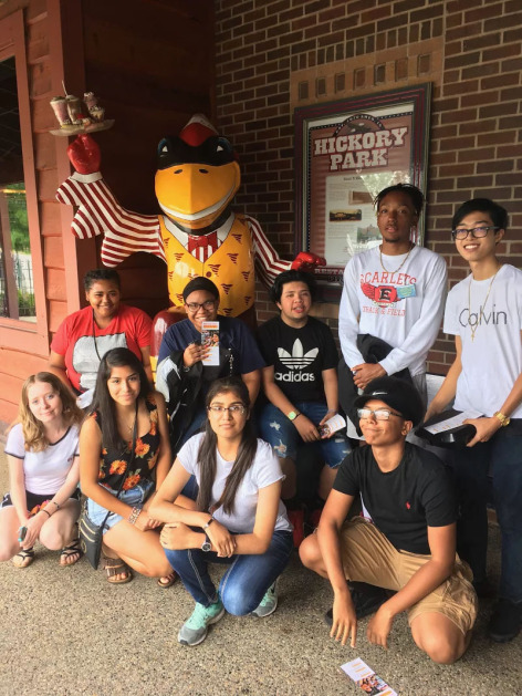 ISU 4U Promise students staying next to CY statue at Hickory Park in Ames