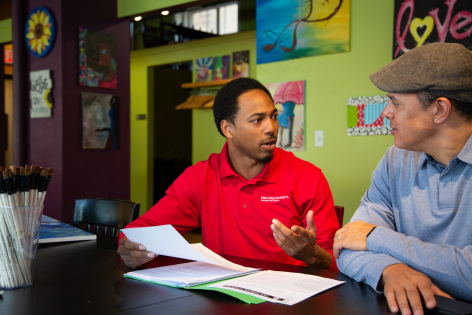 Extension program coordinator working with small business owner