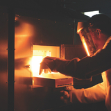 Paul Canfield removes a sample from a flux-growth furnace.