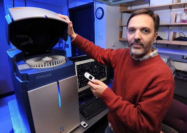 Gustavo MacIntosh operates equipment in his ISU laboratory