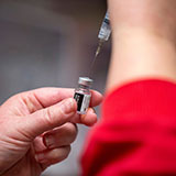 Closeup of vaccine needle and vial