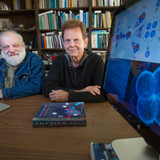 Andrey Shrokov of Moscow State University in Russia, who has been a visiting scientist at Iowa State, and James Vary of Iowa State with computer images of a "tetraneutron."