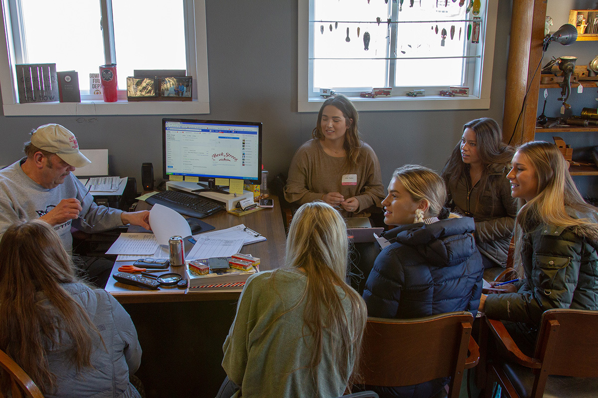 Emily Schrimpf and her team meeting with Greg Benson, owner of Beek Street Antiques & Collectibles in Gowrie, 2019. Photo by Ryan Riley/Iowa State University