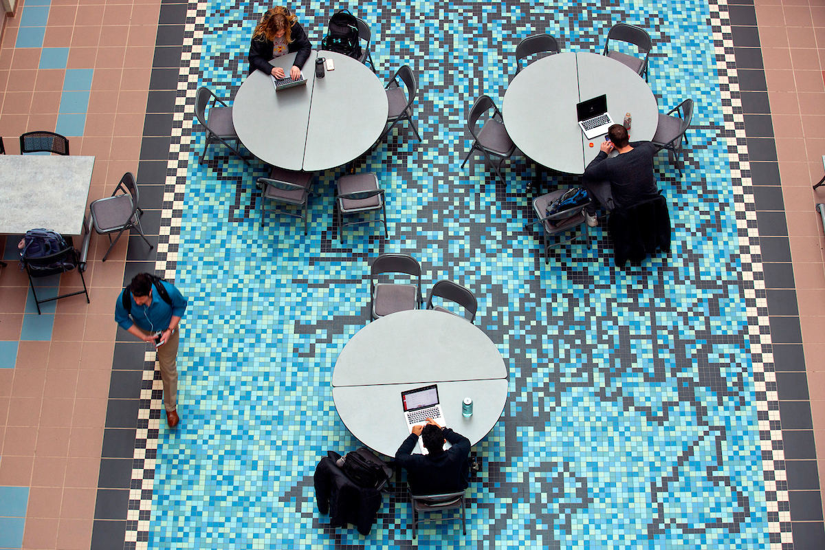 Students work on laptops above “Gene Pool,” a tile mosaic by Andrew Leicester inside the Molecular Biology Building. Photo by Christopher Gannon/Iowa State University.
