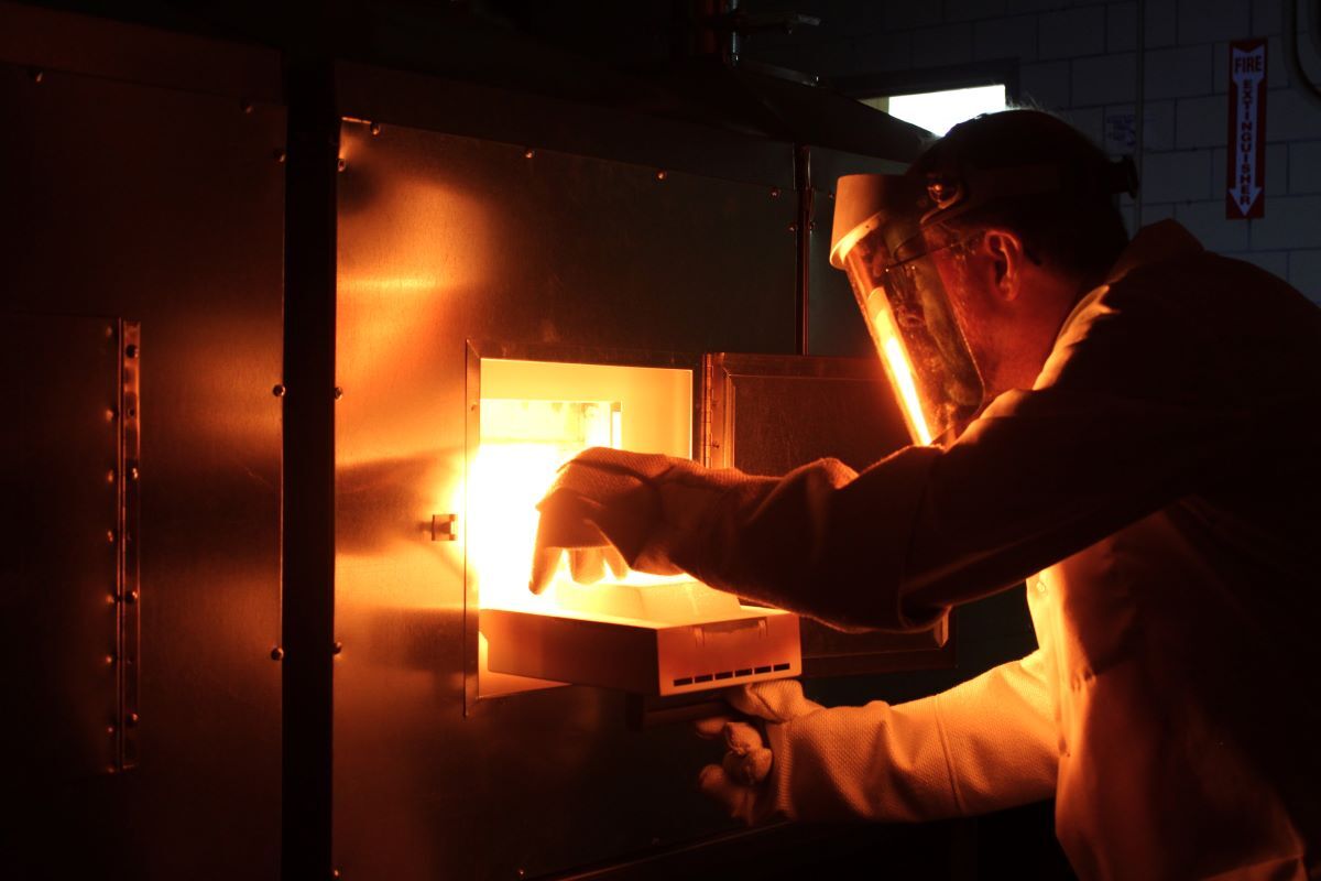 Paul Canfield removes a materials sample from a flux-growth furnace.