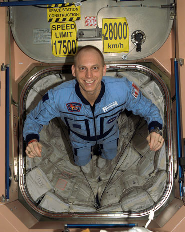 Iowa State University graduate Clayton Anderson flies through the International Space Station.