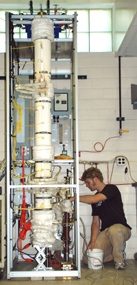 Cody Ellens with free fall reactor that produces bio-oil.