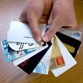 Hands holding credit cards