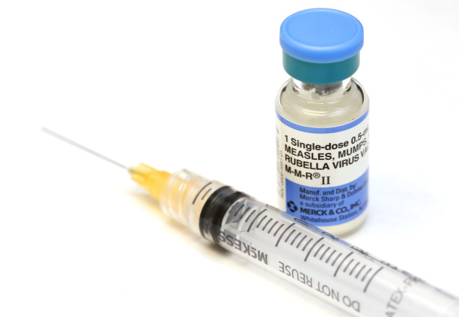Bottle of MMR vaccine and needle