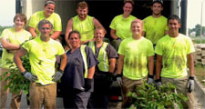 Students and offenders working on prison garden