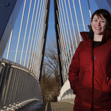 Katy Swalwell standing on I-235 pedestrian bridge in Des Moines 
