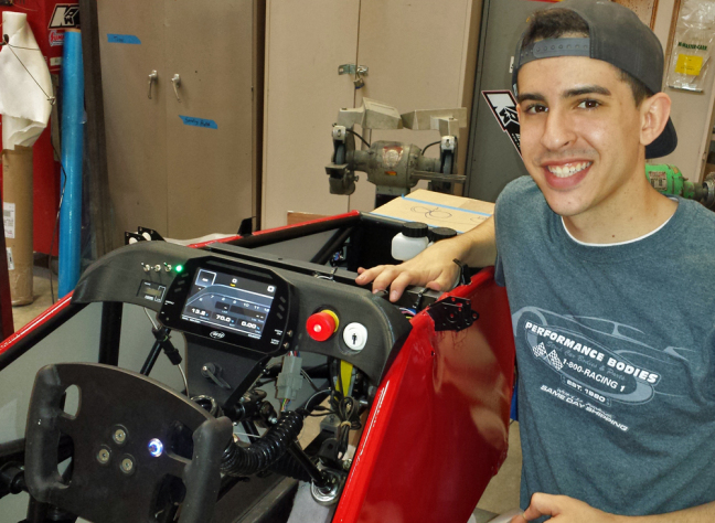 Michael Hauptmann works on this year's mini-formula racer in Cyclone Racing's campus garage.