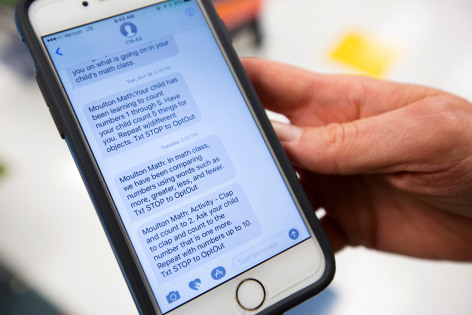 Mobile phone with examples of text messages sent to parents