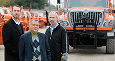 ISU researchers and DOT maintenance manager stand near snow plow