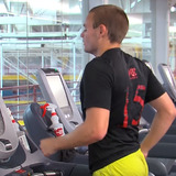 People running on treadmills at gym 