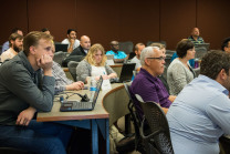 Students take notes in class for Business Analytics program