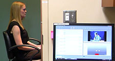 Woman in neuroscience lab using eye tracking technology