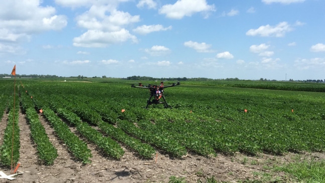 An unmanned aerial vehicle lands in a farm field