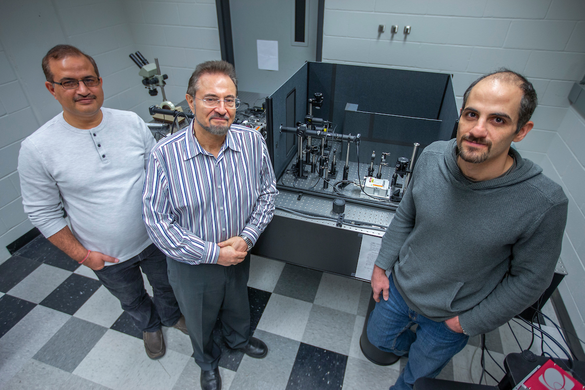Krishan Kumar Pandey, Valery Levitas and Mehdi Kamrani, left to right, study materials subject to high pressures in Levitas' Iowa State University laboratory.