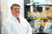 Paul Plummer in lab coat in a lab at the ISU College of Veterinary Medicine