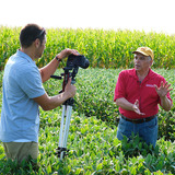 Extension specialists recording video in farm field