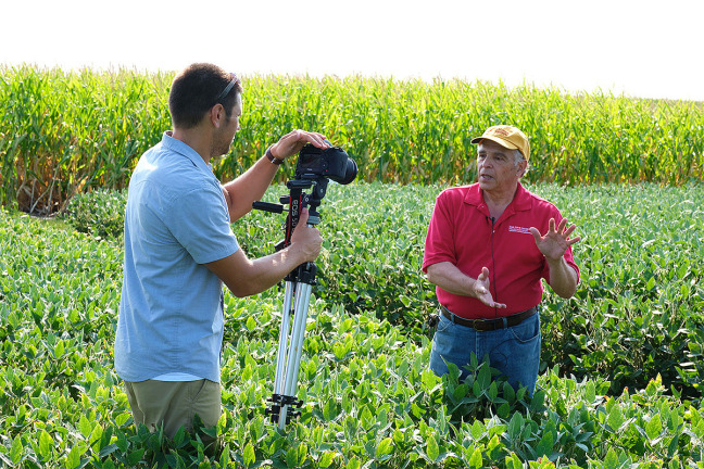 Extension specialists recording video in farm field