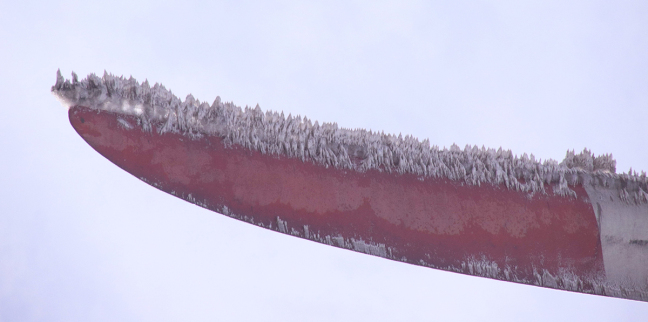 A drone photo showing nearly a foot of ice on the tip of a wind turbine blade.