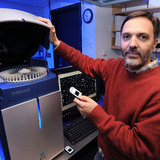 Gustavo MacIntosh operates equipment in his ISU laboratory