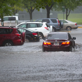 A car drives through a flooded parking lot at Iowa State University in 2018. Christopher Gannon/Iowa State University
