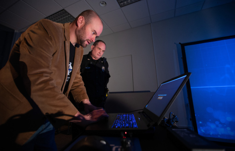 Kyle Burgason, left, associate professor of Criminal Justice, and ISU Police Chief Michael Newton set up the VirTra-100 simulator in East Hall, Feb. 2022.