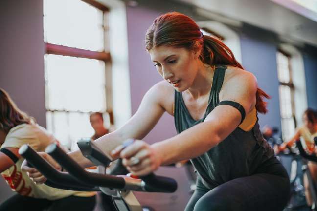 A woman cycles in spin class at Iowa State University