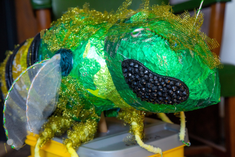 A sweat bee puppet made from discarded materials.