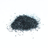 Black powedery biomass scattered on a bright white surface