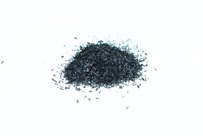 Black powedery biomass scattered on a bright white surface