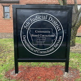 A sign for the Fifth Judicial District Department of Correctional Services in Des Moines, IA.