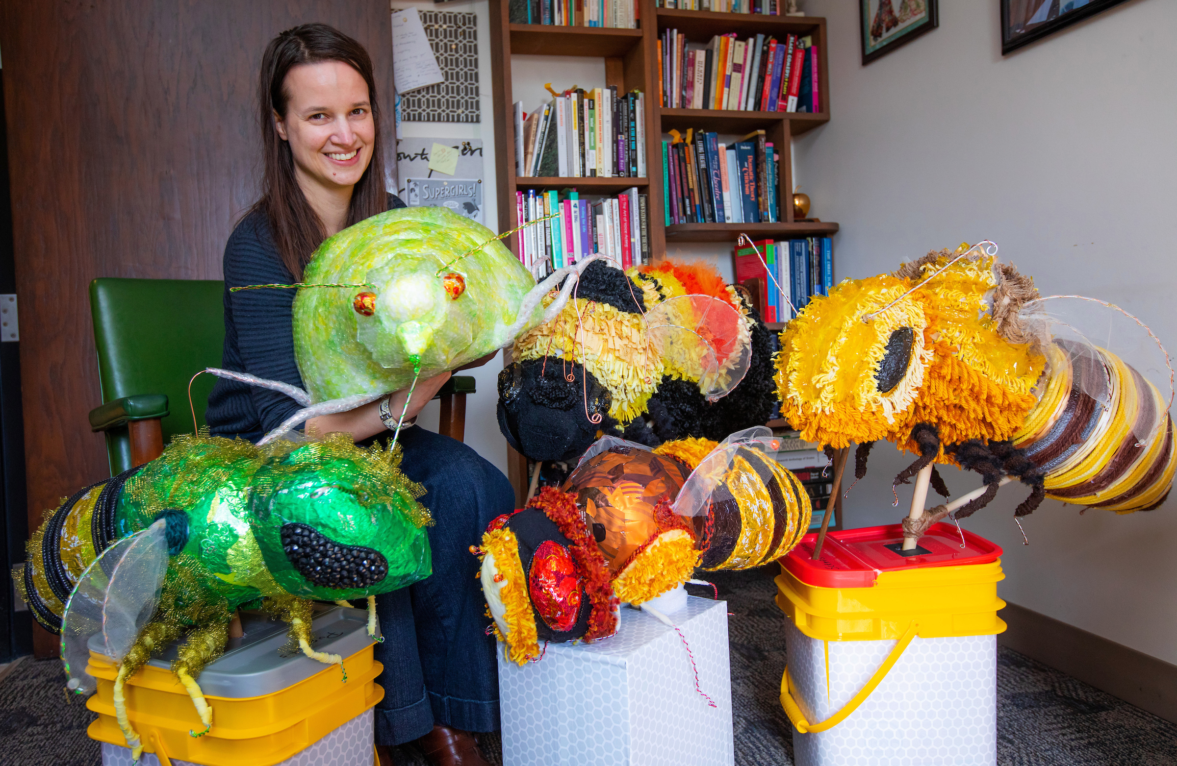 Amanda Petefish-Schrag, Associate Professor of Theatre, surrounded by some of the insect puppets that will be on display this week in the Iowa Insect Pageant
