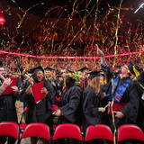 Students celebrate during commencement ceremony in Hilton Coliseum