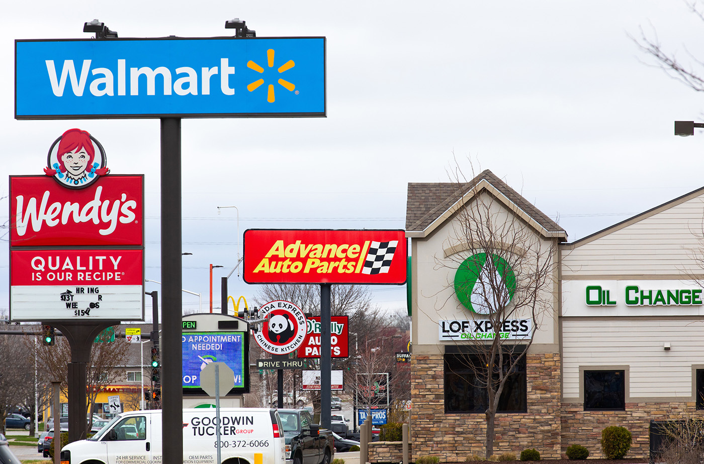 Retail signs on Duff Avenue in Ames, IA, April 2021. Christopher Gannon/Iowa State University